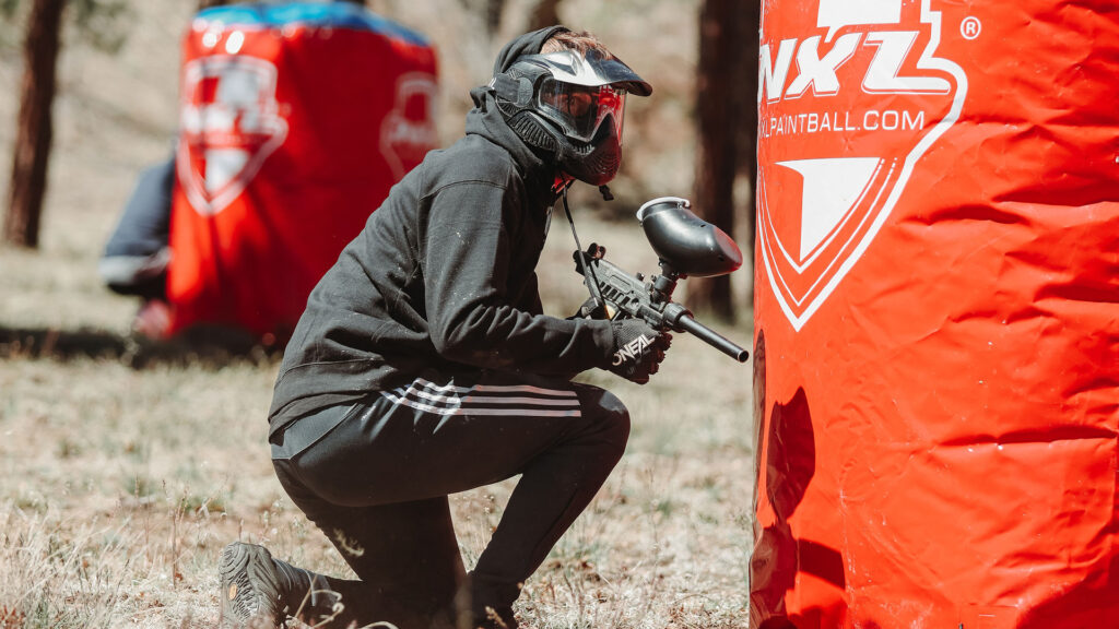 Paintball Player Hides Behind Bunker