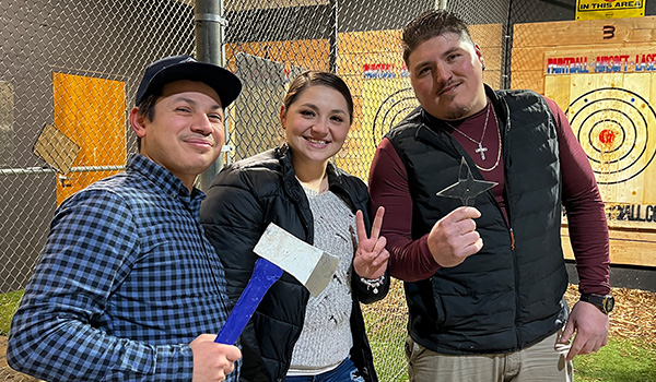 Friends throwing axes together