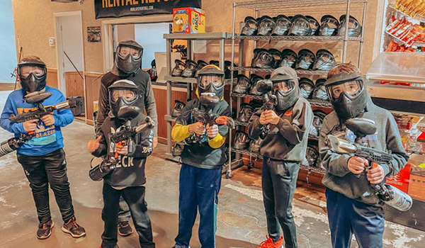 Kids birthday party playing paintball