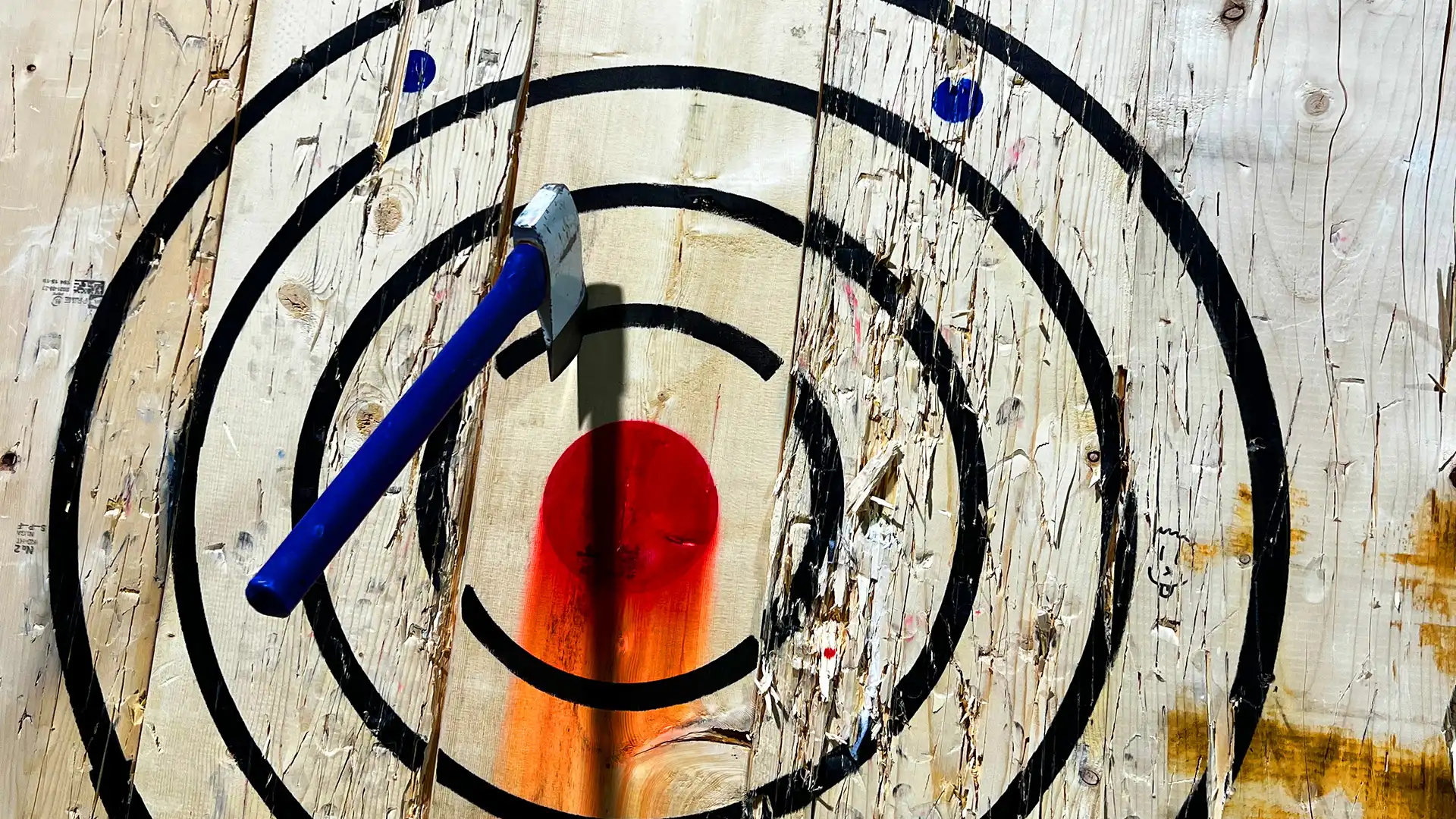 axe stuck into an axe throwing target near the bullseye
